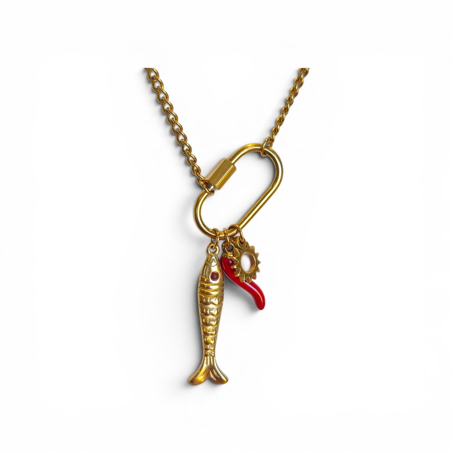 Gold necklace with a fish charm and red detail on a white background