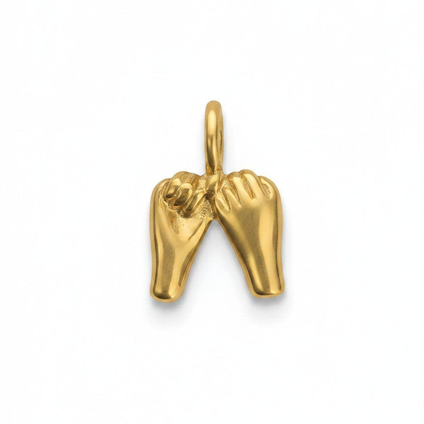 Gold charm shaped like a pair of hands on a white background