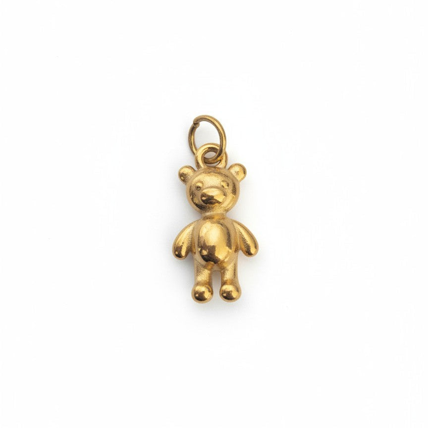 Gold earring with clear gemstones on a white background